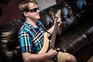 Blake Hardin holding his Shawn Lane Vigier guitar